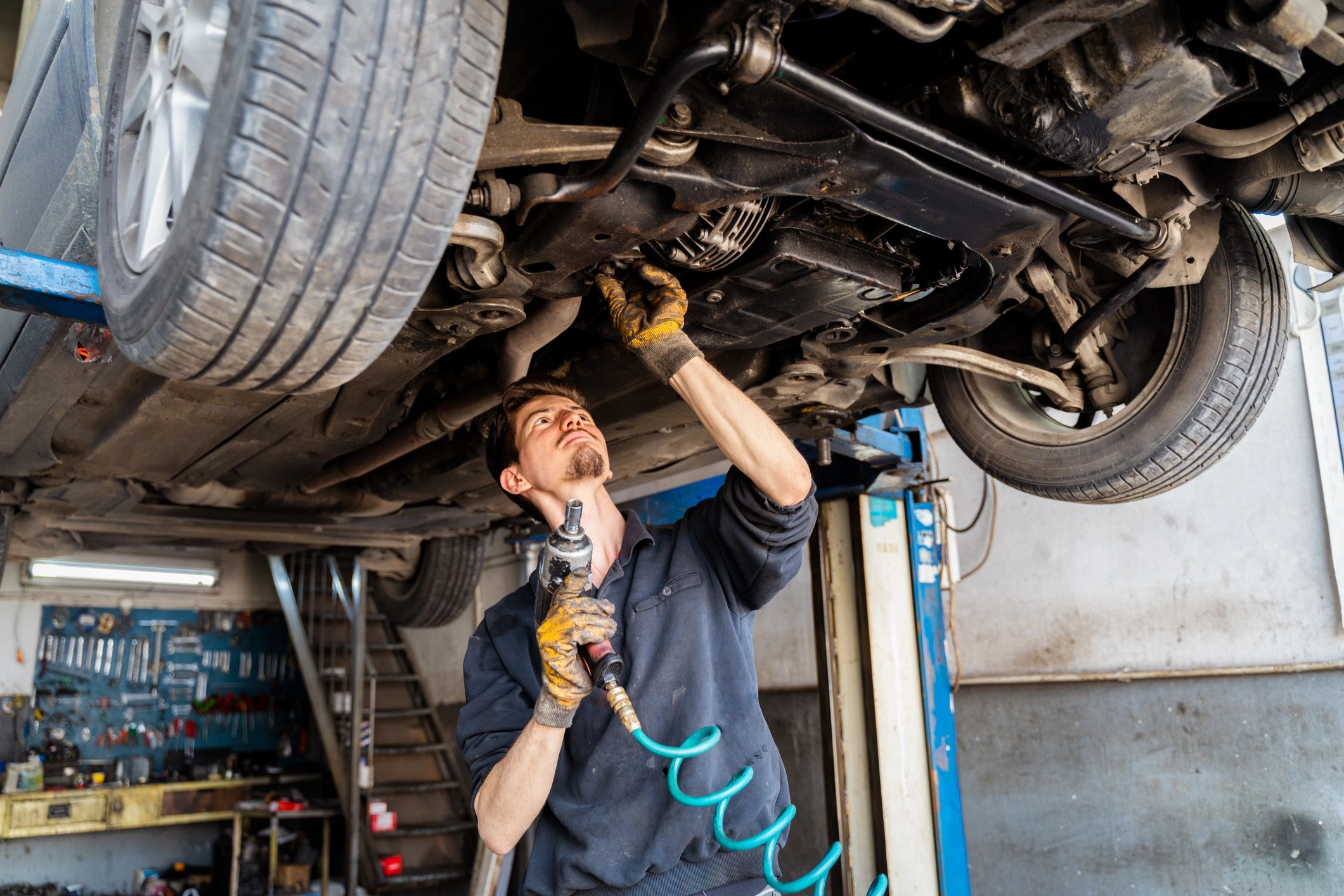 Mechanic inspecting vehicle components